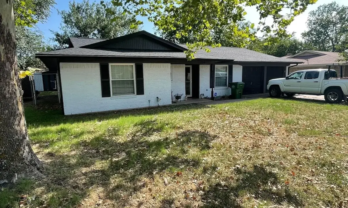 Professional roofing crew working on a residential roof in Fairwood